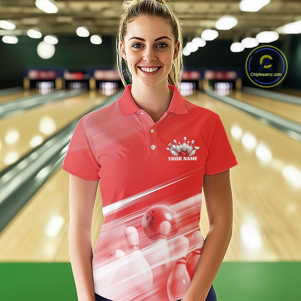 Front view female model at the bowling lane wearing a red bowling polo shirt with bowling ball and pins geometric artwork.