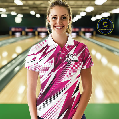 Woman wearing a pink and white bowling shirt with a logo in a bowling alley.