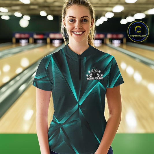 Woman wearing a teal bowling shirt with a personalized logo in a bowling alley.