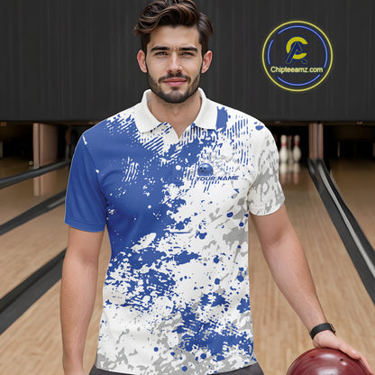 Front view of a male model in a bowling lane wearing a blue and white splatter polo shirt with minimalist bowling-inspired graphics.