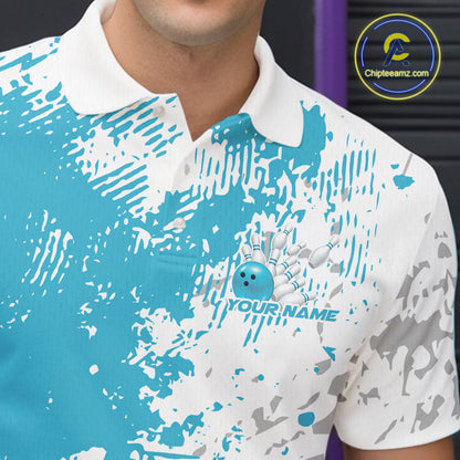 Close-up view of the left chest of a teal blue and white splatter bowling polo shirt showing abstract modern bowling-inspired graphics.