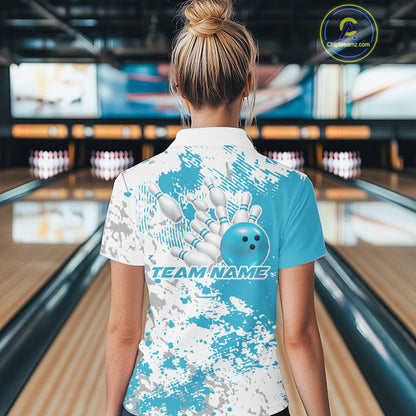 Back view of a female model in a bowling lane wearing a teal blue and white splatter bowling quarter-zip shirt with sporty bowling-inspired design accents.