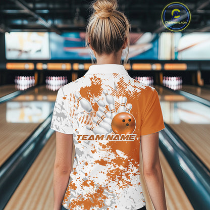 Back view of a female model in a bowling lane wearing a bowling quarter-zip shirt featuring orange and white splatter pattern with clean sporty bowling visuals.