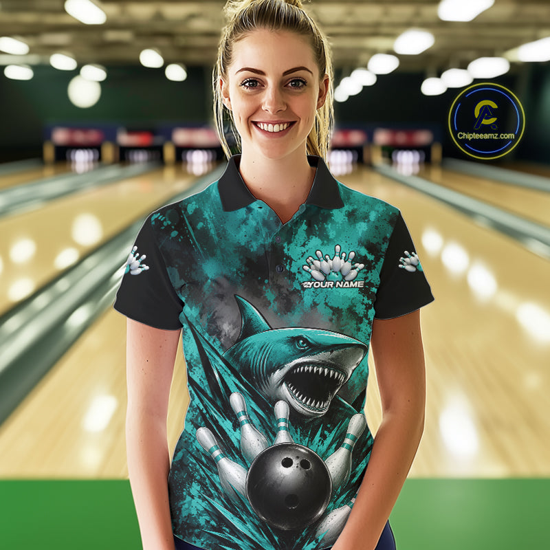 Woman wearing a bowling shirt with a shark design in a bowling alley.