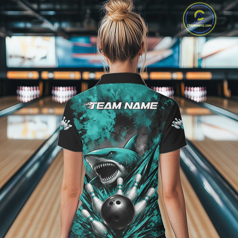 Person wearing a bowling shirt with a shark design in a bowling alley