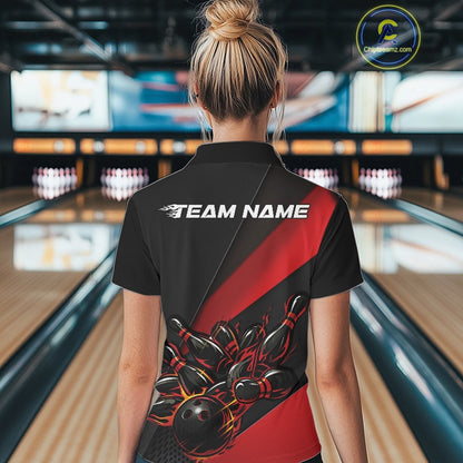 Female model back view at bowling center wearing black and red polo shirt showcasing flame bowling ball striking pins in bold dynamic artwork.