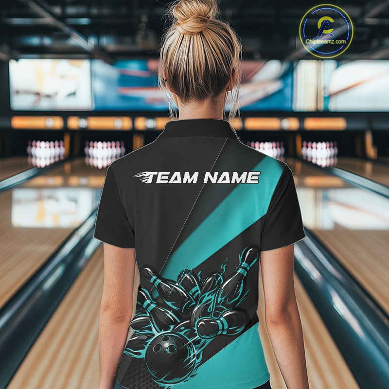 Female model back view in bowling venue wearing black and turquoise blue polo shirt showcasing flame bowling ball striking pins in clean motion design.