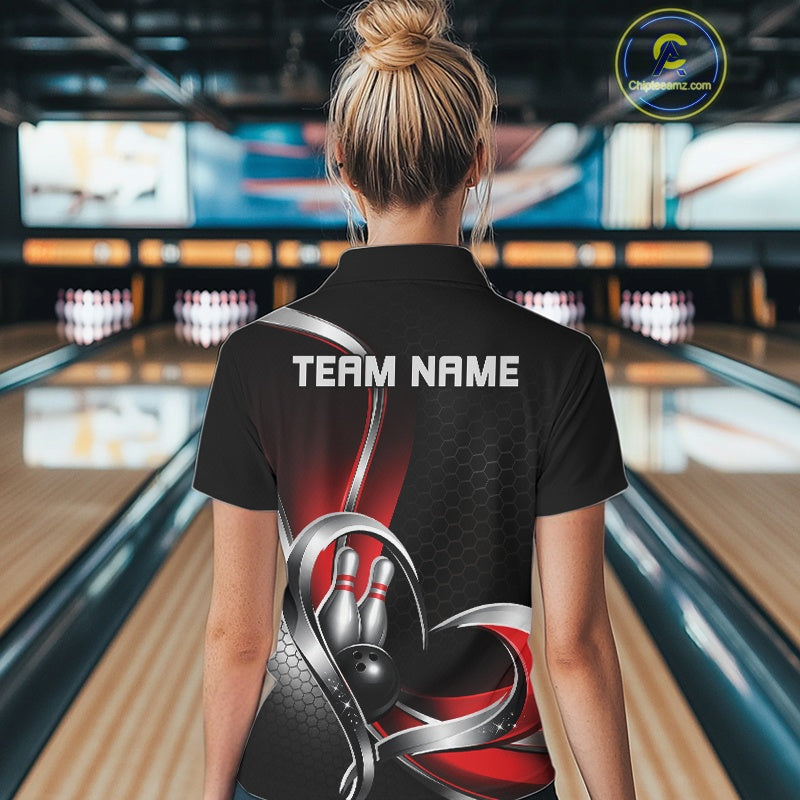 Back view of a female model in a bowling venue wearing a black and red quarter zip shirt with honeycomb pattern and heart-shaped bowling action design.