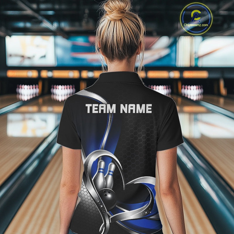 Back view of a female model in a bowling center wearing a black and blue quarter zip shirt with honeycomb graphics and heart-framed bowling action scene.