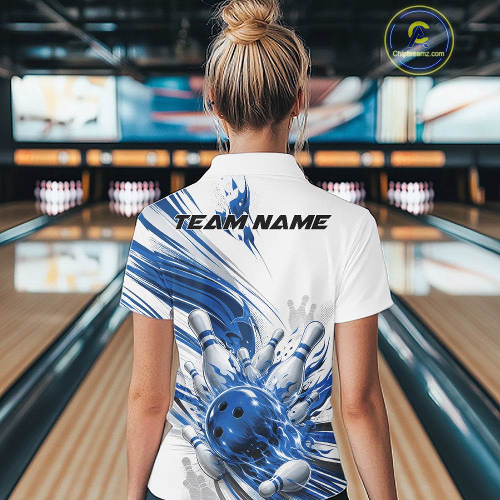A woman viewed from behind wearing a white short-sleeve bowling-themed polo shirt with a blue and white graphic of a bowling ball and pins, set in a bowling alley.