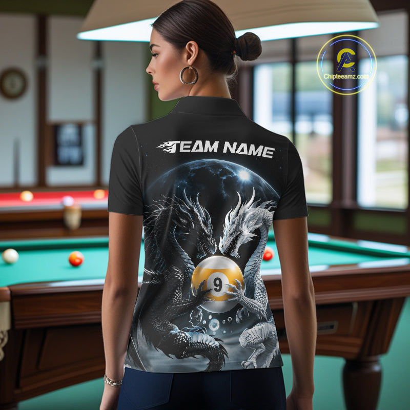 A woman stands in a billiards room wearing a black short-sleeve polo shirt with a large back graphic featuring dragons, a 9-ball,