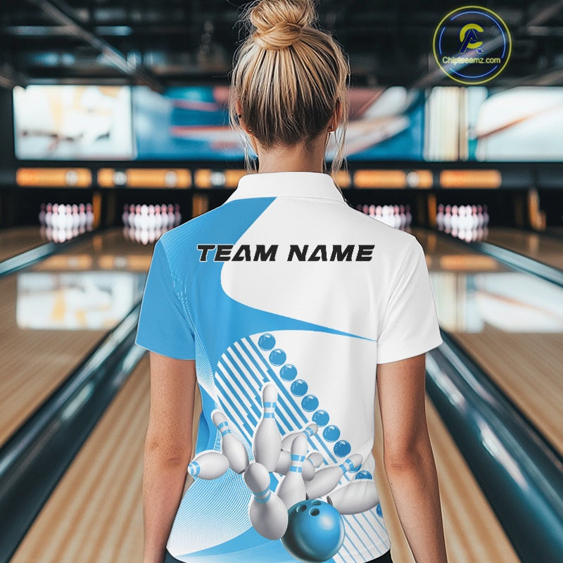 Back view of a female model in a bowling lane wearing a white and light blue polo shirt, showcasing wavy asymmetric stripe accents and bowling action artwork.