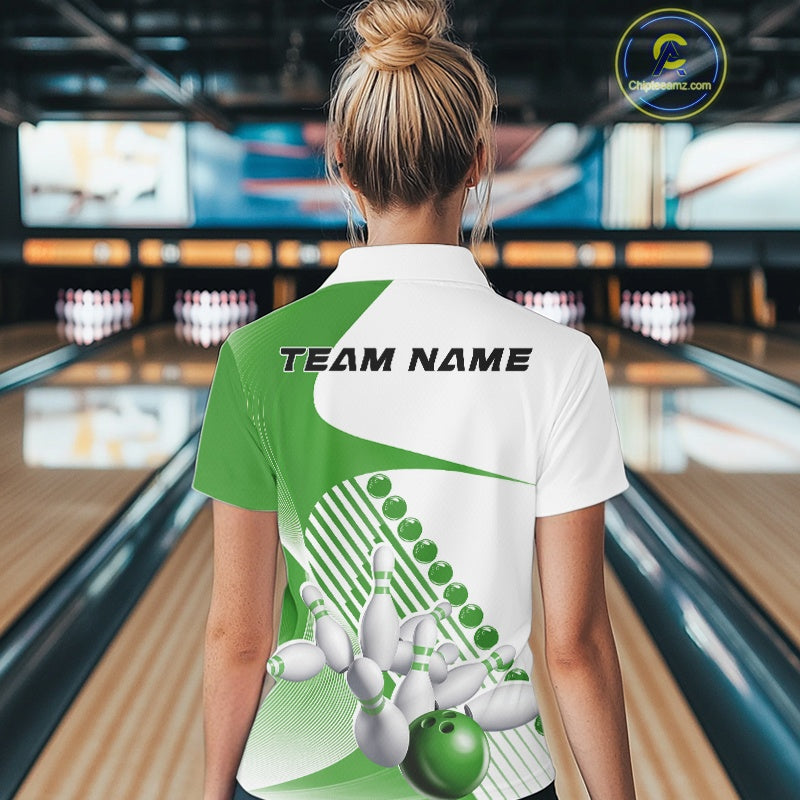 Back view of a female model in a bowling venue wearing a white and green polo shirt, showcasing asymmetric stripe patterns and a dynamic bowling action design.