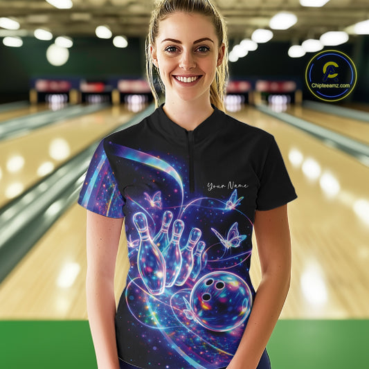 Female model wearing a black bowling quarter zip with starry galaxy graphics, glowing neon swirls, and hologram butterflies, front view