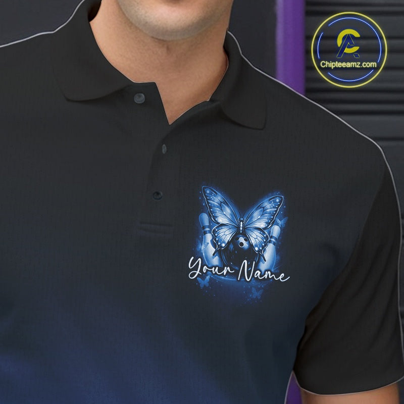 Close-up left chest view of a blue bowling polo shirt featuring glowing butterflies on a bowling ball with fallen bowling pins.