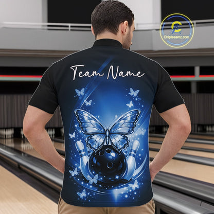 Front view of a male model in a bowling venue wearing a blue quarter-zip shirt featuring luminous butterflies and cosmic bowling artwork.