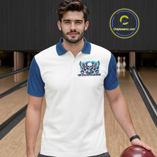 Load image into Gallery viewer, Front view of a male model in a bowling alley wearing a bowling polo shirt featuring a gothic skull with wings, bowling ball, pins, and ornamental swirls with a personalized name on a white and blue design.
