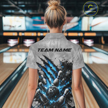 Load image into Gallery viewer, Back view of a female model wearing a gray bowling polo shirt with a dramatic blue bowling ball and pins graphic accented by claw-mark artwork in a bowling lane.