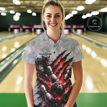 Load image into Gallery viewer, Front view of a female model wearing a gray bowling polo shirt featuring a dramatic red bowling ball and pins graphic with claw-mark artwork at a bowling lane.