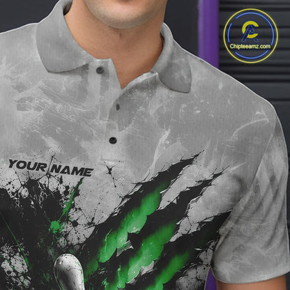 Close-up of the left chest on a gray bowling polo shirt featuring a dramatic green bowling ball and pins graphic with claw-mark artwork.