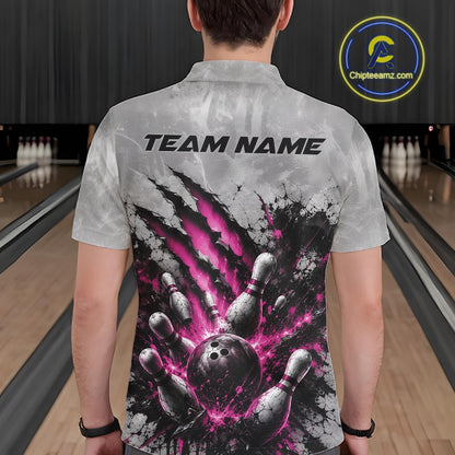 Back view of a male model wearing a gray bowling polo shirt featuring a dramatic pink bowling ball and pins graphic with claw-mark artwork in a bowling lane.