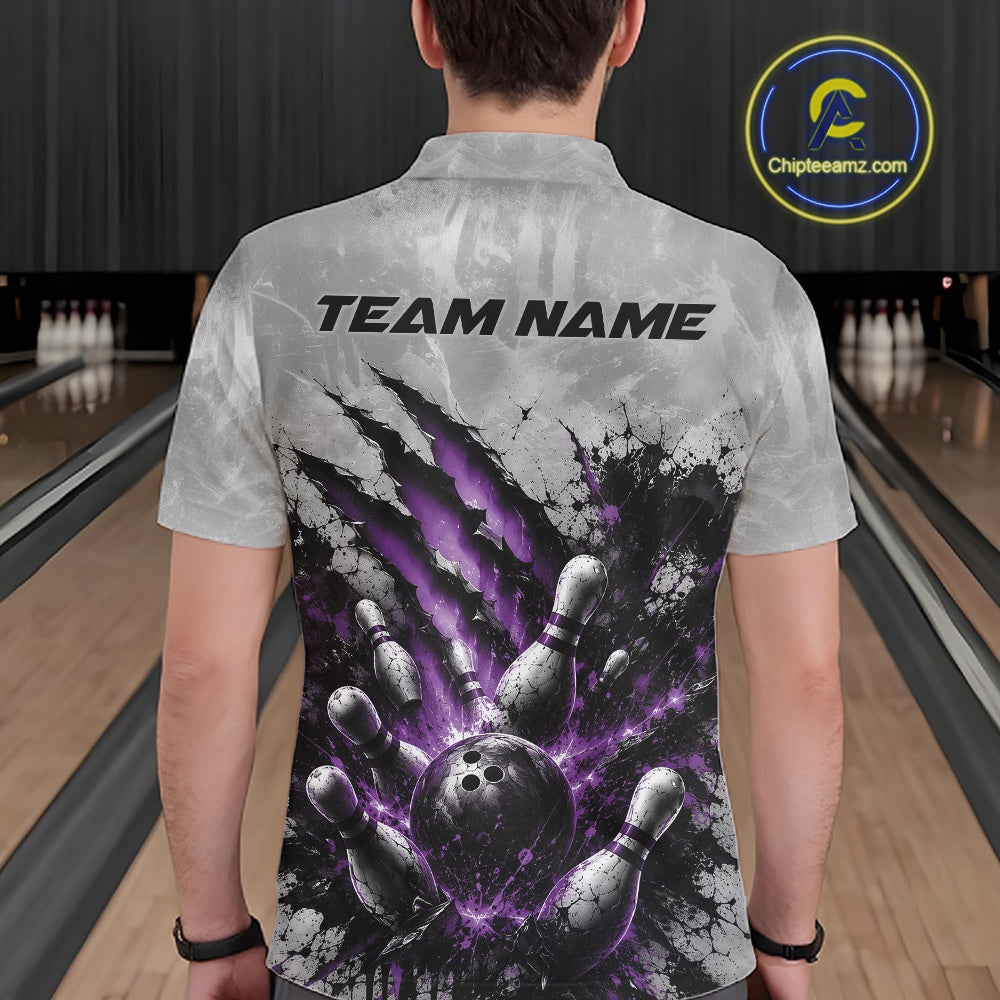Back view of a male model wearing a gray bowling polo shirt with a dramatic purple bowling ball striking pins graphic accented by claw-mark artwork in a bowling lane.