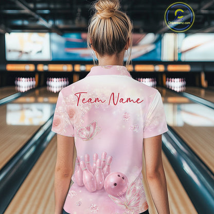Back view of a female model at a bowling lane wearing a polo shirt featuring pink glitter butterflies, diamonds, bowling pins, and a bowling ball.