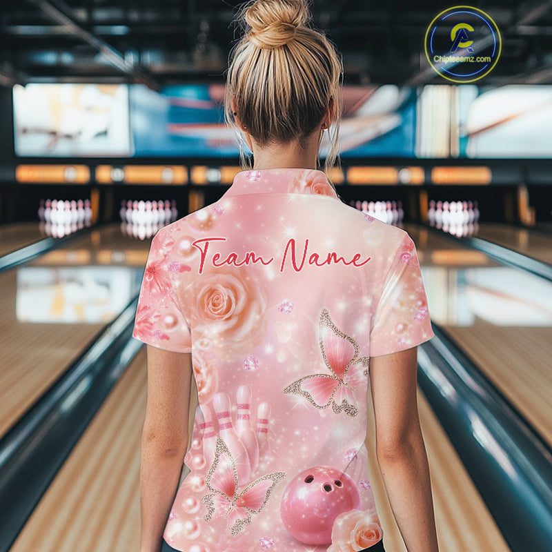 Back view of a female model in a bowling center wearing a quarter-zip shirt with glitter butterflies, diamonds, bowling pins, and bowling-themed accents.