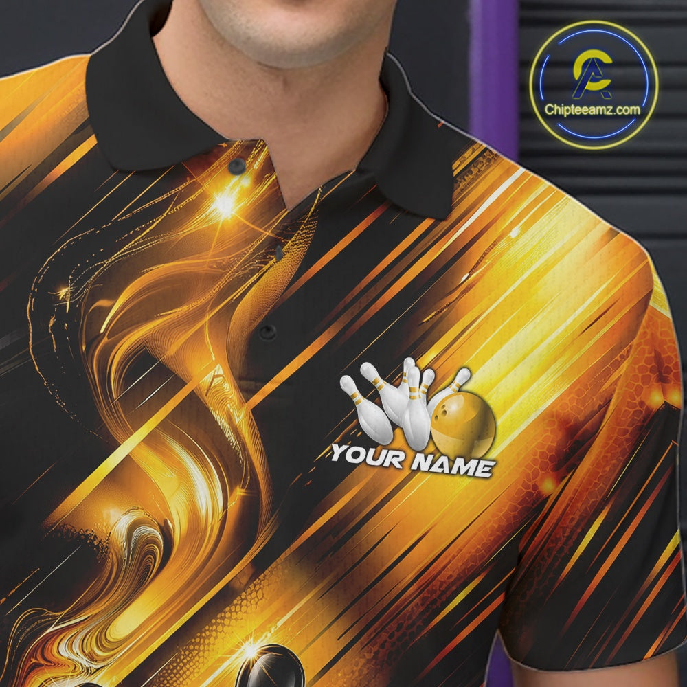 Close-up view of the left chest of a bowling polo shirt featuring a black and gold bowling ball striking pins with flowing metallic ribbon accents.