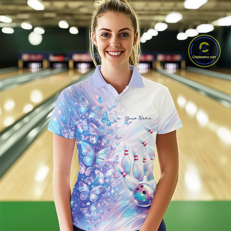 Front view of a female model wearing a bowling polo with pastel purple and pink holographic butterflies and vibrant bowling-themed graphics