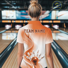 Load image into Gallery viewer, Back view of a female model wearing a white and orange bowling polo shirt with flowing wave artwork and a bowling strike graphic in a bowling alley