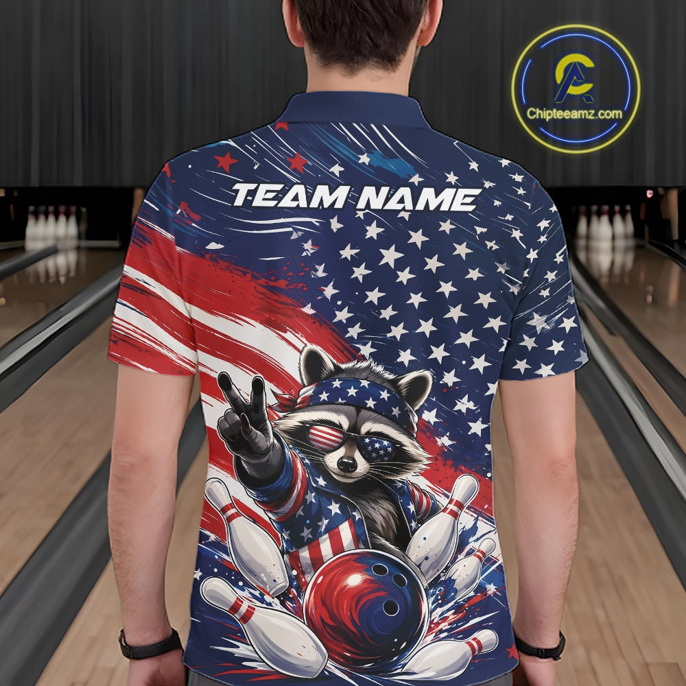 Back view of a male model wearing a bowling polo shirt showcasing a patriotic raccoon flashing a peace sign, a red, white, and blue bowling ball knocking down pins, and an American flag in a bowling lane.
