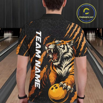 Back view of a male model wearing a black and yellow bowling polo shirt at a bowling lane, featuring a roaring tiger holding a yellow bowling ball with orange claw-stripe artwork and a geometric background pattern.