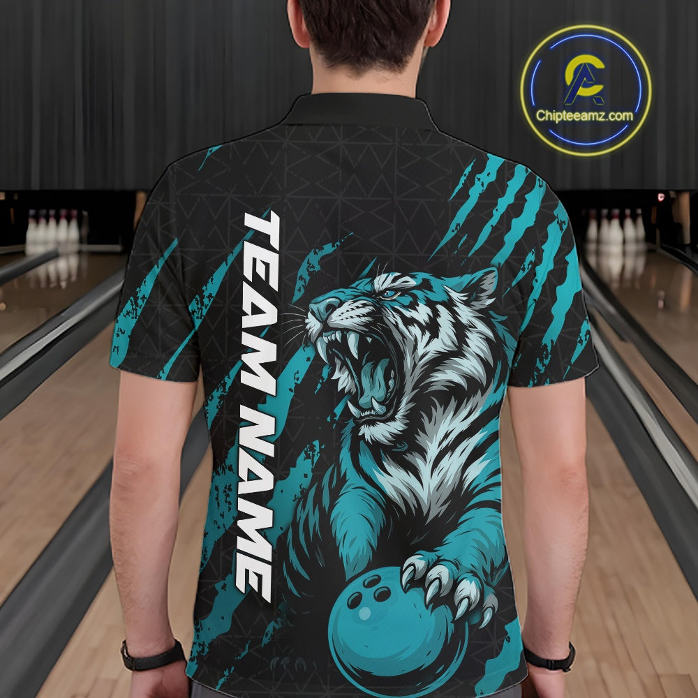 Back view of a male model wearing a black and teal blue bowling polo shirt in a bowling lane, featuring a roaring tiger holding a teal blue bowling ball with teal blue claw-stripe artwork and a geometric background pattern.