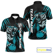 Load image into Gallery viewer, Front and back view of a black and teal blue men's bowling polo shirt featuring a roaring tiger holding a teal blue bowling ball with matching claw-stripe graphics and a geometric background pattern.