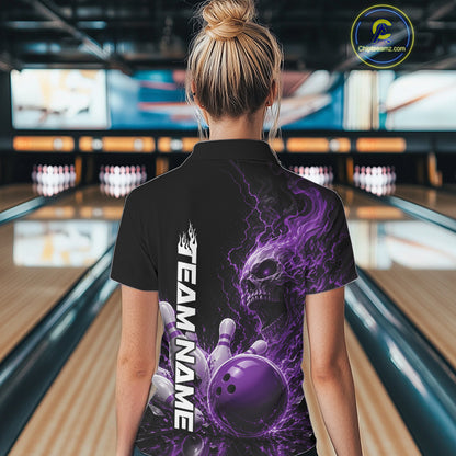 Back view of a female model in a bowling alley wearing a black bowling polo with a purple flaming skull, lightning, bowling pins, and a custom name.
