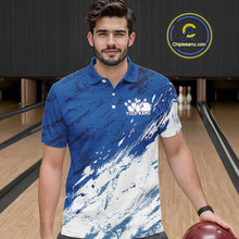 Load image into Gallery viewer, Front view of a male bowler in a bowling alley wearing a white and blue bowling polo shirt with a dynamic splatter style sports jersey design