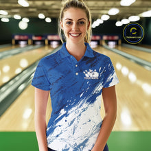 Load image into Gallery viewer, Front view of a female bowler wearing a white and blue bowling polo shirt with a splatter-inspired sports jersey design in a bowling lane