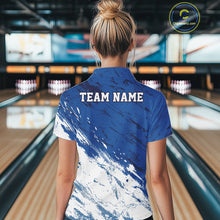 Load image into Gallery viewer, Back view of a female bowler wearing a white and blue bowling quarter-zip shirt with a splatter-inspired sports jersey design in a bowling lane
