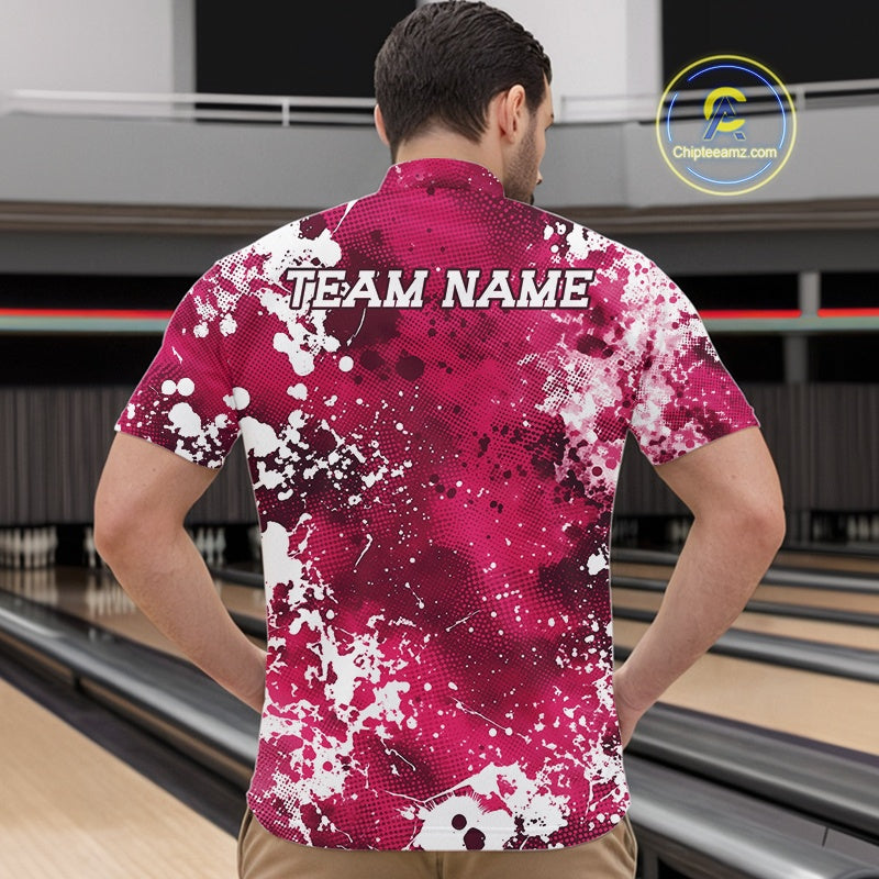 Person wearing a pink and white patterned bowling shirt with 'TEAM NAME' on the back, standing in front of a bowling alley.