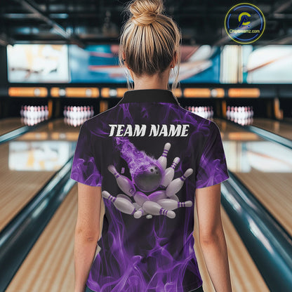 Back view of a female model in a bowling alley wearing a black and purple bowling polo with a flaming bowling strike and scattered pins design.