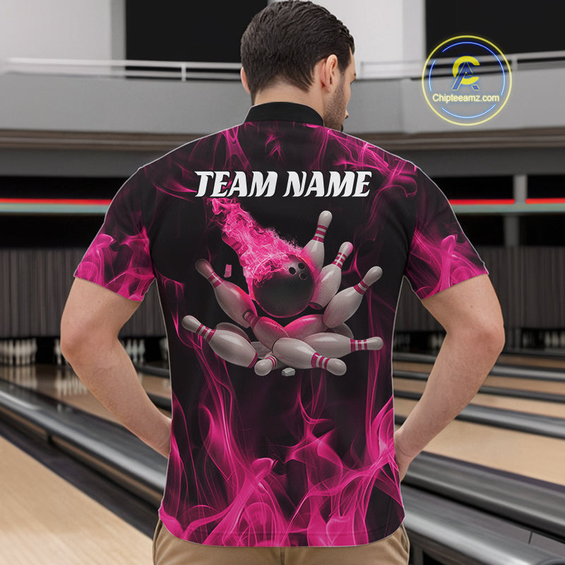 Front view of a male model in a bowling alley wearing a black and pink quarter-zip shirt featuring scattered bowling pins and flame-themed graphics.