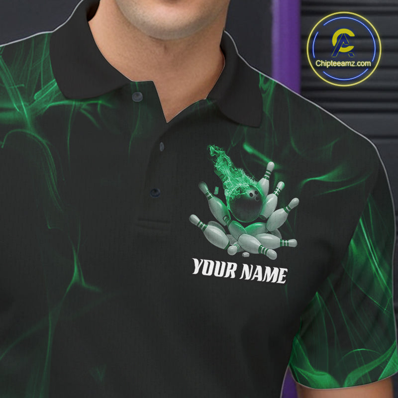 Male model at a bowling lane wearing a black and green bowling polo shirt with scattered pins and fiery bowling action design.