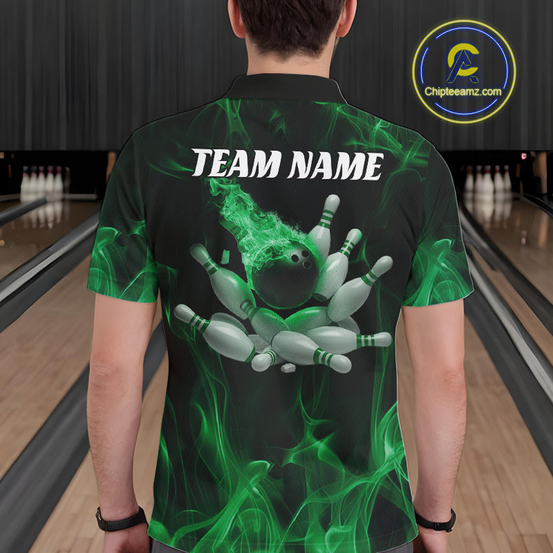 Back view of a male model in a bowling alley wearing a black and green polo featuring bowling ball impact graphics and flame effects.