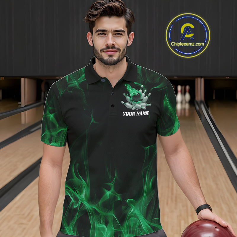Close-up of a black and green bowling polo shirt left chest showing bowling ball crashing into pins with flames background design.