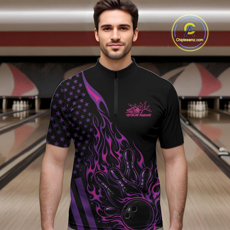 Male model at a bowling lane wearing a black bowling quarter-zip shirt with pink and purple flame bowling artwork and American flag accents.