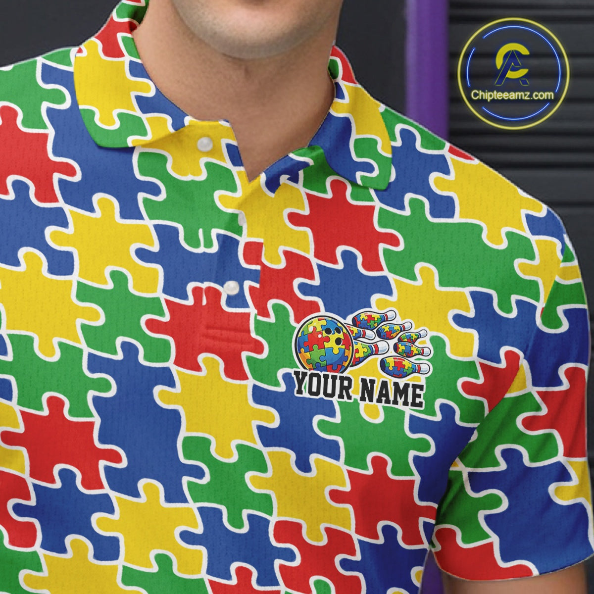 Close-up left chest detail of colorful bowling polo shirt featuring seamless multicolor puzzle pattern design