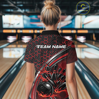 Back view of a black and red women s bowling quarter zip with honeycomb pattern and flame bowling ball knocking down pins artwork inside a bowling center.