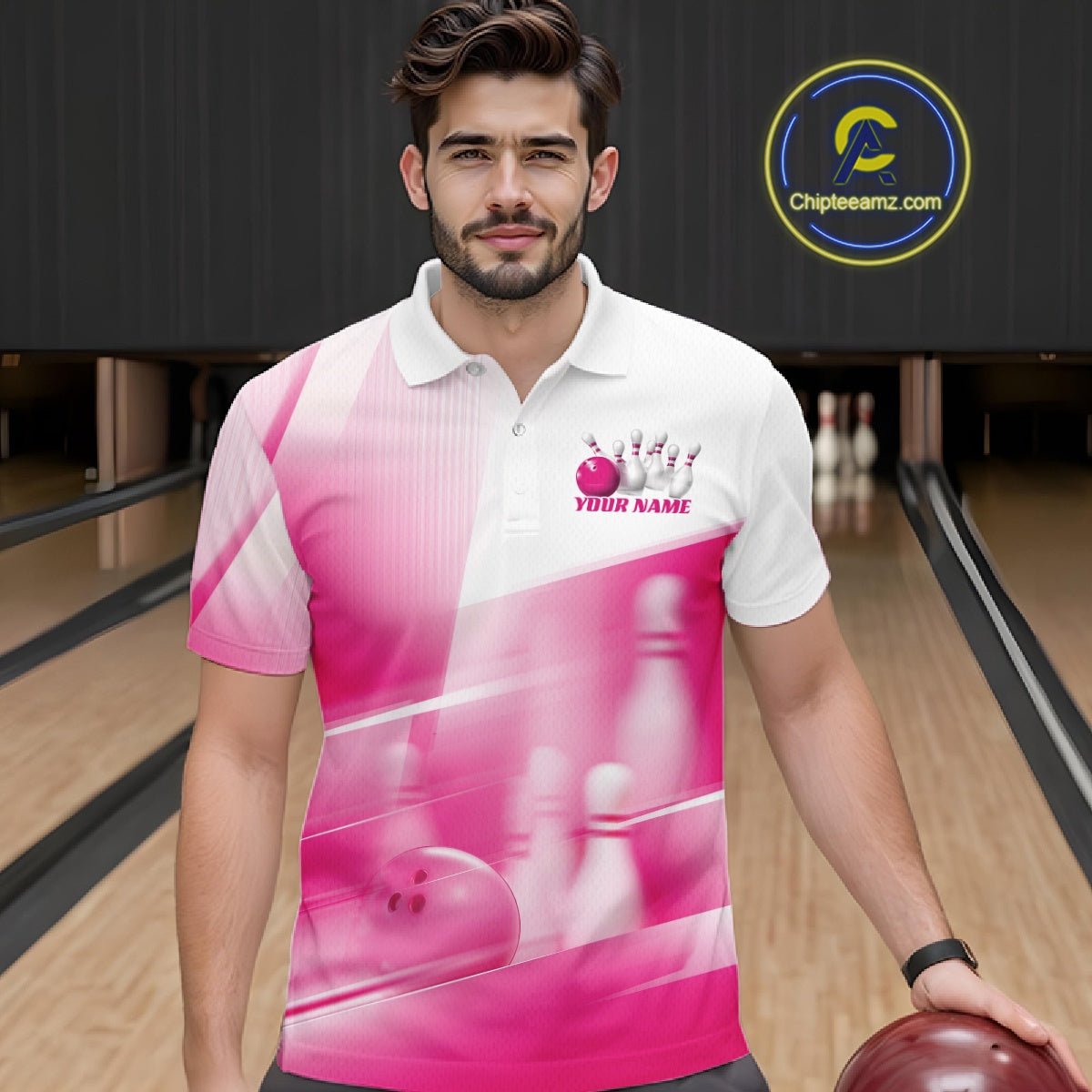 Male model front view at a bowling lane wearing a white and pink bowling polo shirt with bowling ball and pins geometric graphics.