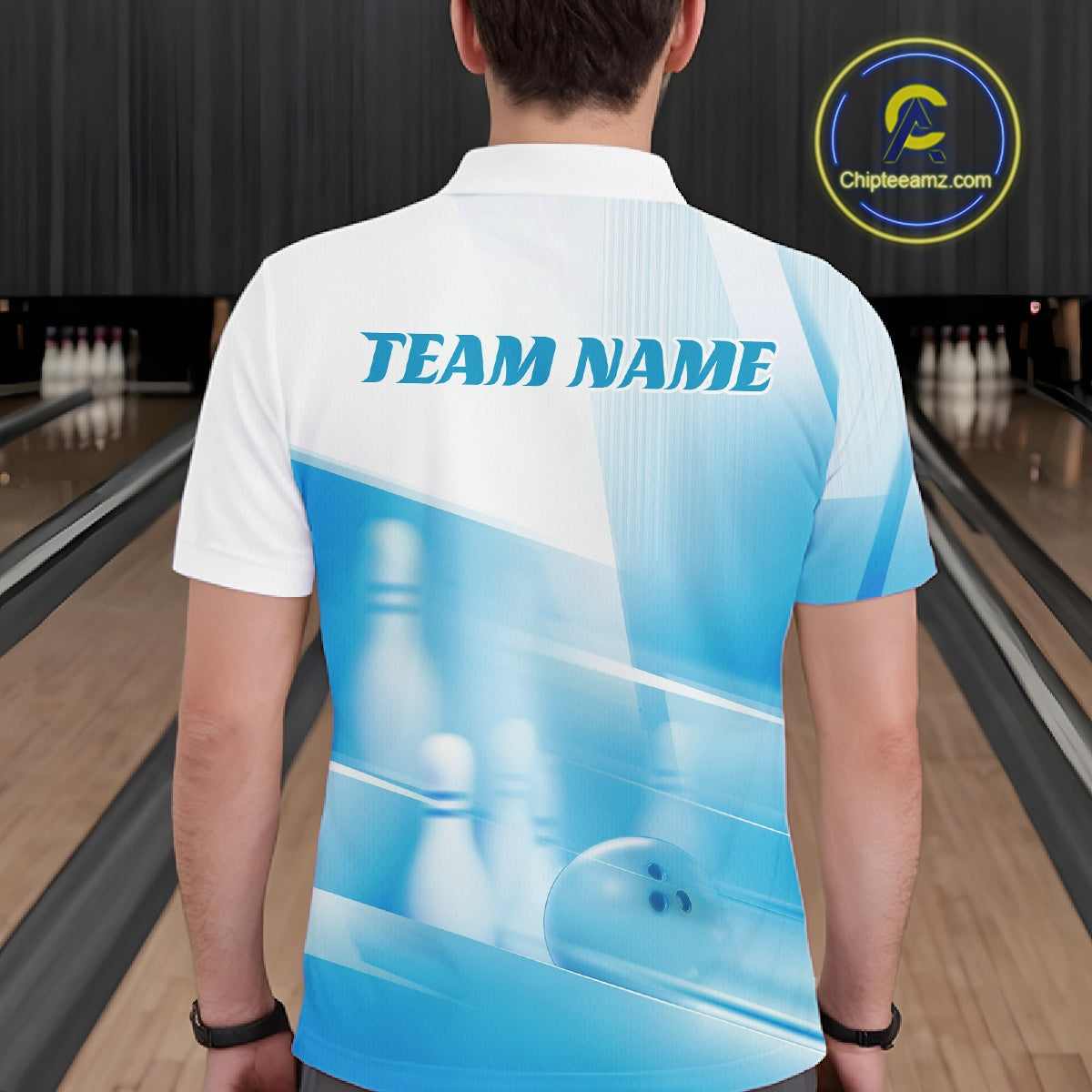Back view of a male model in a bowling lane wearing a white and blue polo shirt with bowling ball and pins over a pink geometric pattern.
